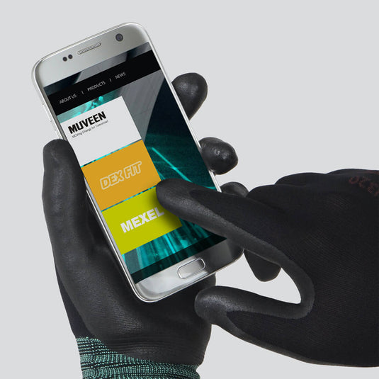The Multi-Purpose Nylon Work Gloves FN320 in Black being worn while using a smartphone, emphasizing its touchscreen capabilities.