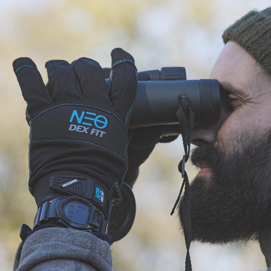 The Mechanic Winter Gloves MG310 being worn while using a telescope outdoor for protecting the hand from any potential danger.