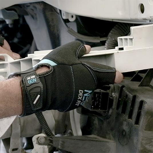 Using the Mechanic Fingerless Gloves MG310 in Gray while doing a task that requires precision, highlighting its maximum dexterity while still offering a layer of protection.