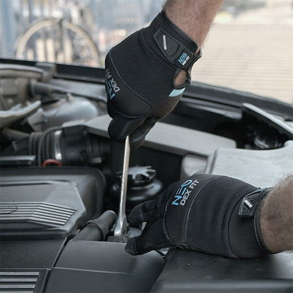Wearing the Mechanic Lightweight Gloves MG310 in Black while using a wrench highlighting the gloves flexibility, durability, and excellent grip.