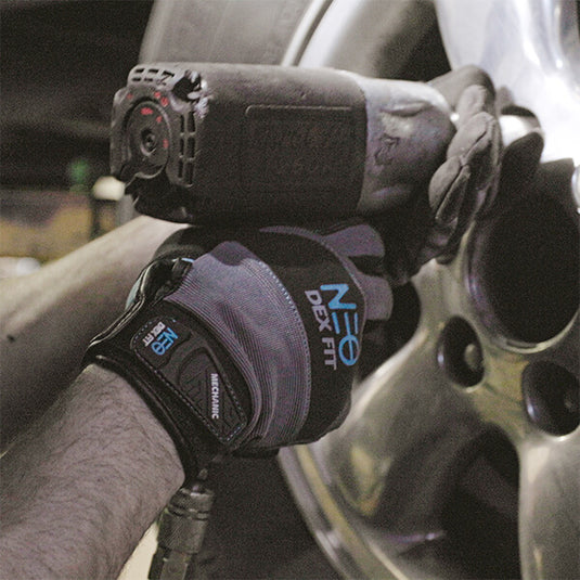 Wearing the Mechanic Lightweight Gloves MG310 in Black while using a wrench gun highlighting the gloves flexibility, durability, and excellent grip.