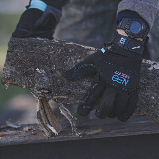 A worker using the the Mechanic Premium Gloves MG310 while carrying a heavy piece of wood showing its excellent grip on any surface.