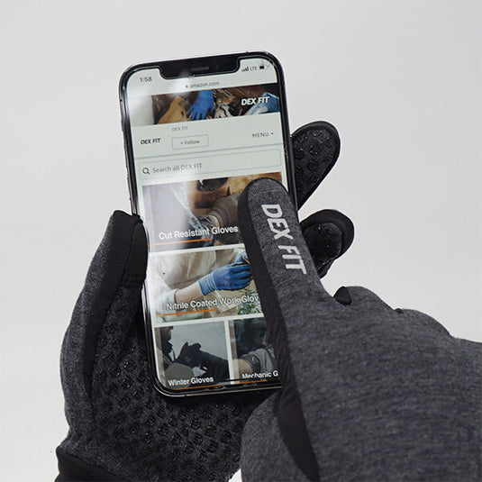 The Warm Outdoor Gloves LG201 being worn while using a smartphone, emphasizing its touchscreen capabilities.