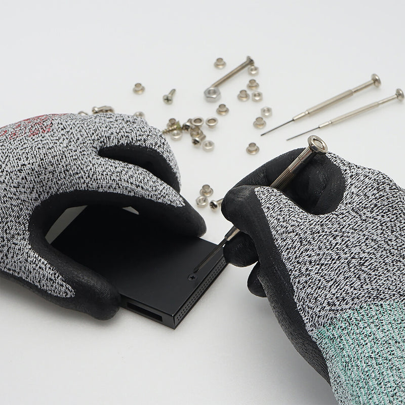 Load image into Gallery viewer, The Level 2 Cut Resistant Gloves CR533 being used in a task requiring precision, showing its great grip, comfort, and flexibility.
