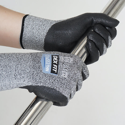 The Level 4 Cut Resistant Gloves Cru553 Thin and its foam nitrile-coating on the palm and fingertips providing superior grip while holding on a metal pipe.