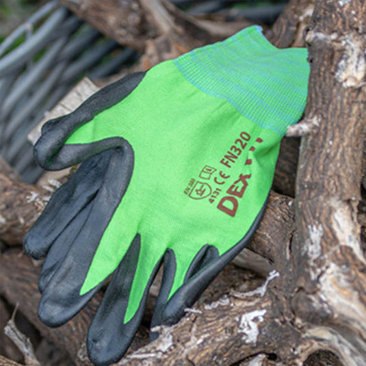 The Multi-Purpose Nylon Work Gloves FN320 in Green on the ground outdoor, highlighting its ability to be perfect for working in any job environment. 