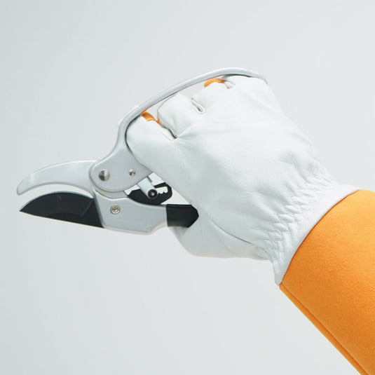 The Leather Gardening Gloves FG310 being used for easy gripping and holding tools for everyday tasks. 