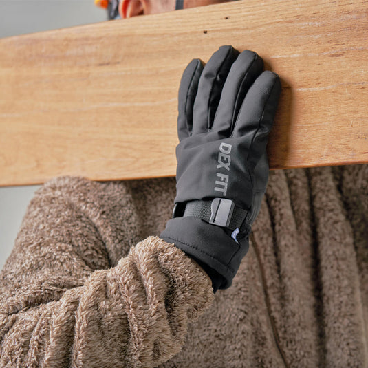 A worker using the Black Thermal Winter Gloves WG201 carrying a heavy piece of wood showing its excellent grip on any surface.