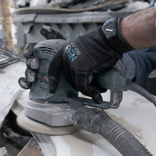 Wearing the Mechanic Premium Gloves MG310 while using a car buffer, highlighting its excellent and safe grip, making it easy to hold various tools.